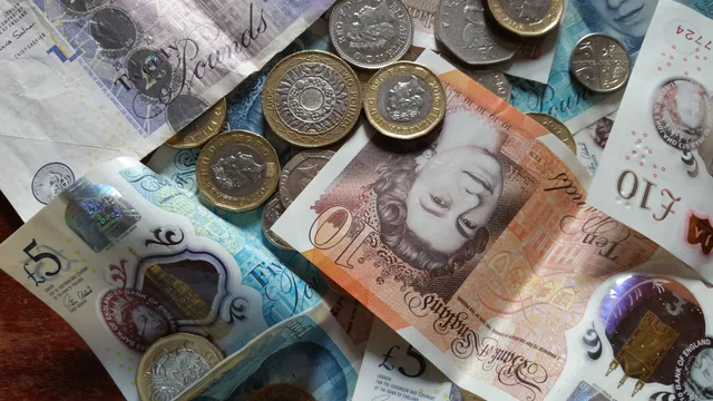 Close-up collection of British Pound notes and coins, showcasing UK currency. How to review an accounting service in England: official records to check and a bounded verdict
